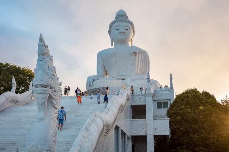 Large white marble Big Buddha statue seen from the main viewing area in Phuket