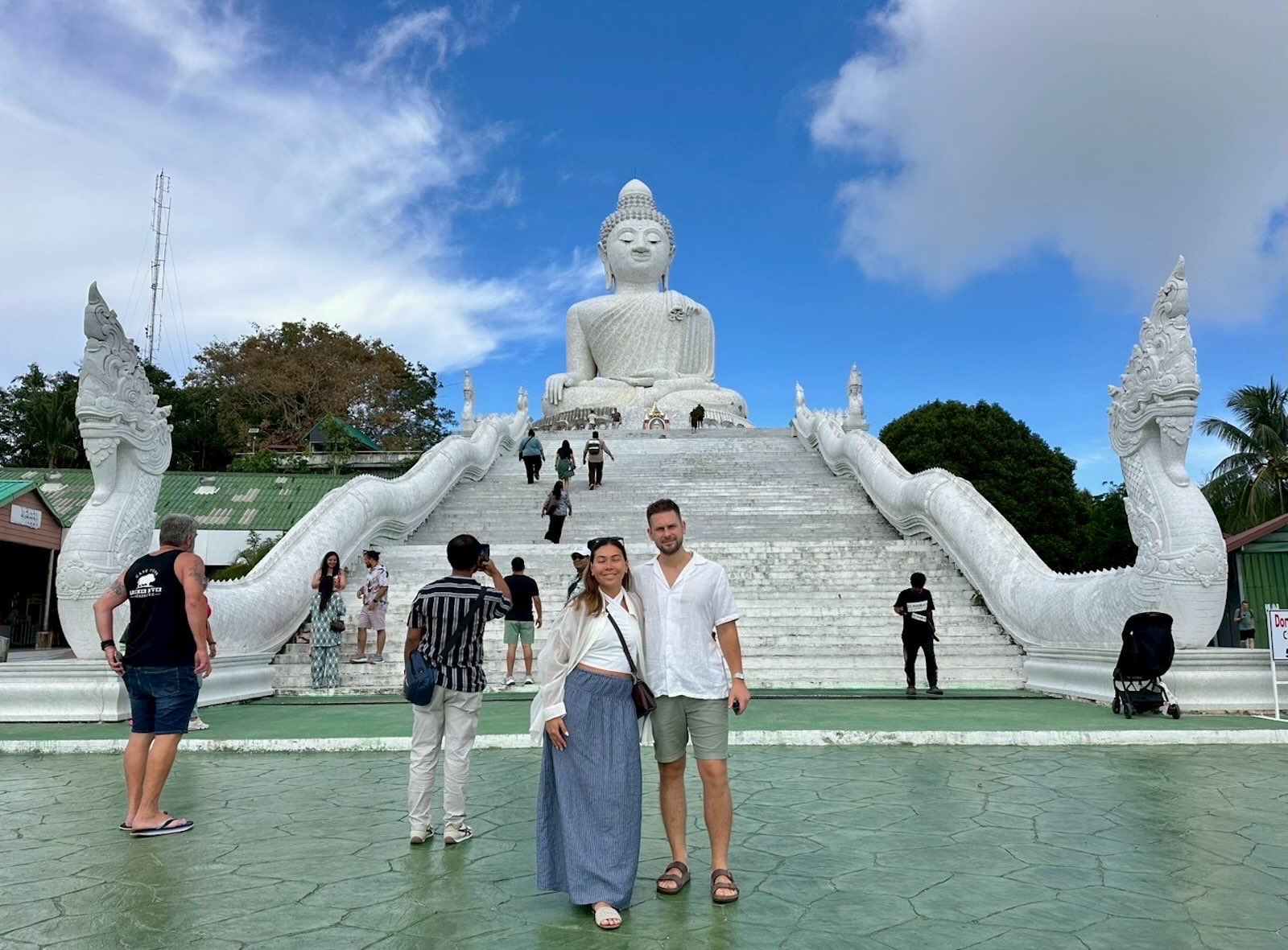 Respectfully dressed visitors with covered shoulders and knees at Big Buddha Phuket